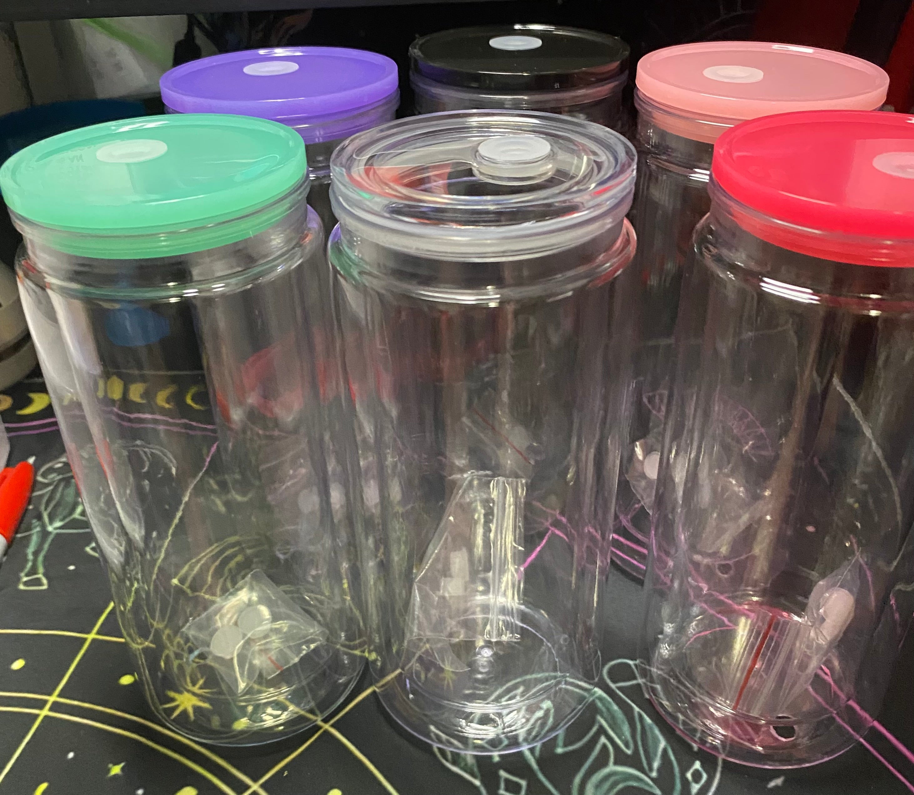 Clear plastic tumblers with colorful lids 
