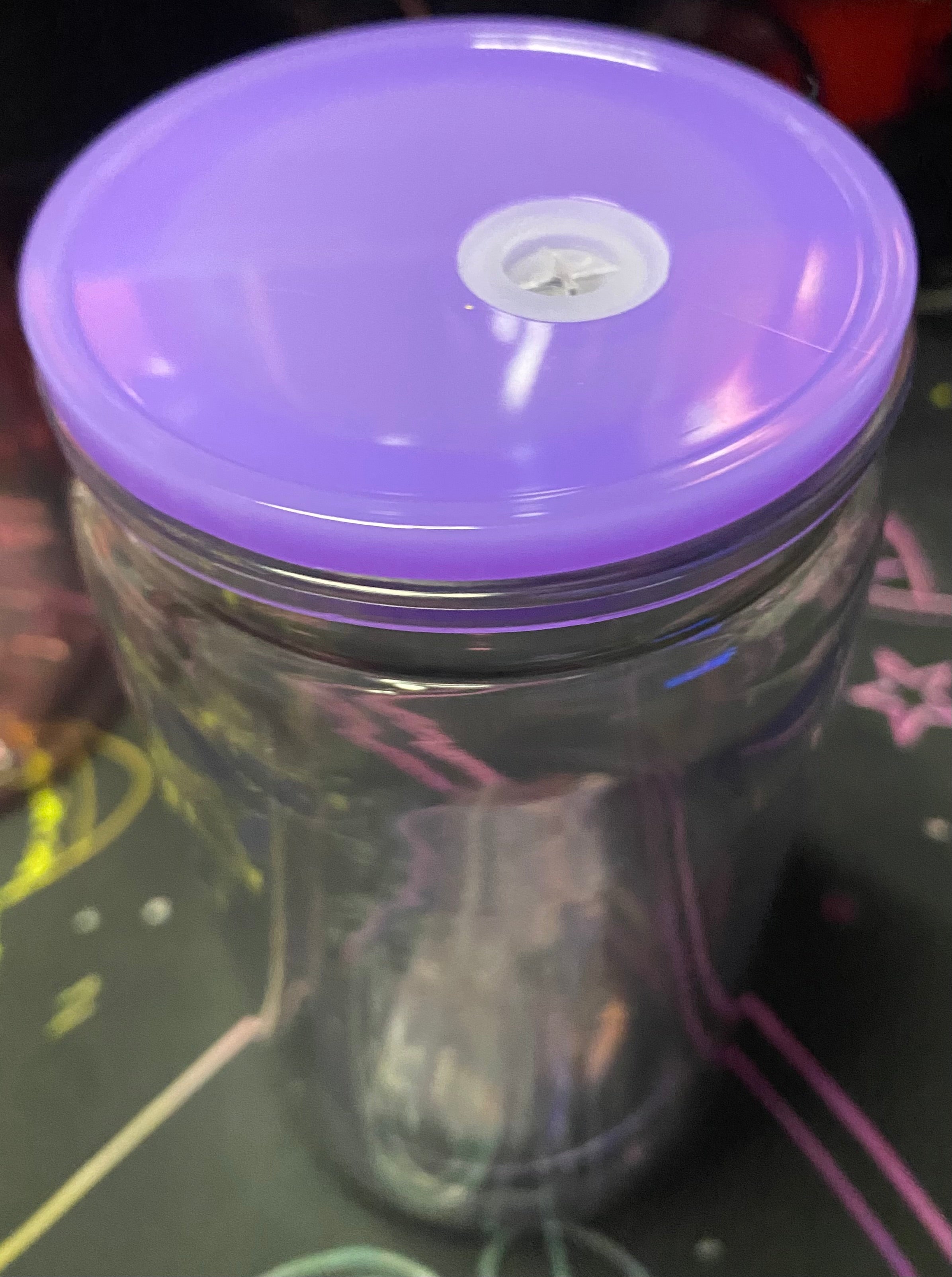 Clear container with a purple lid