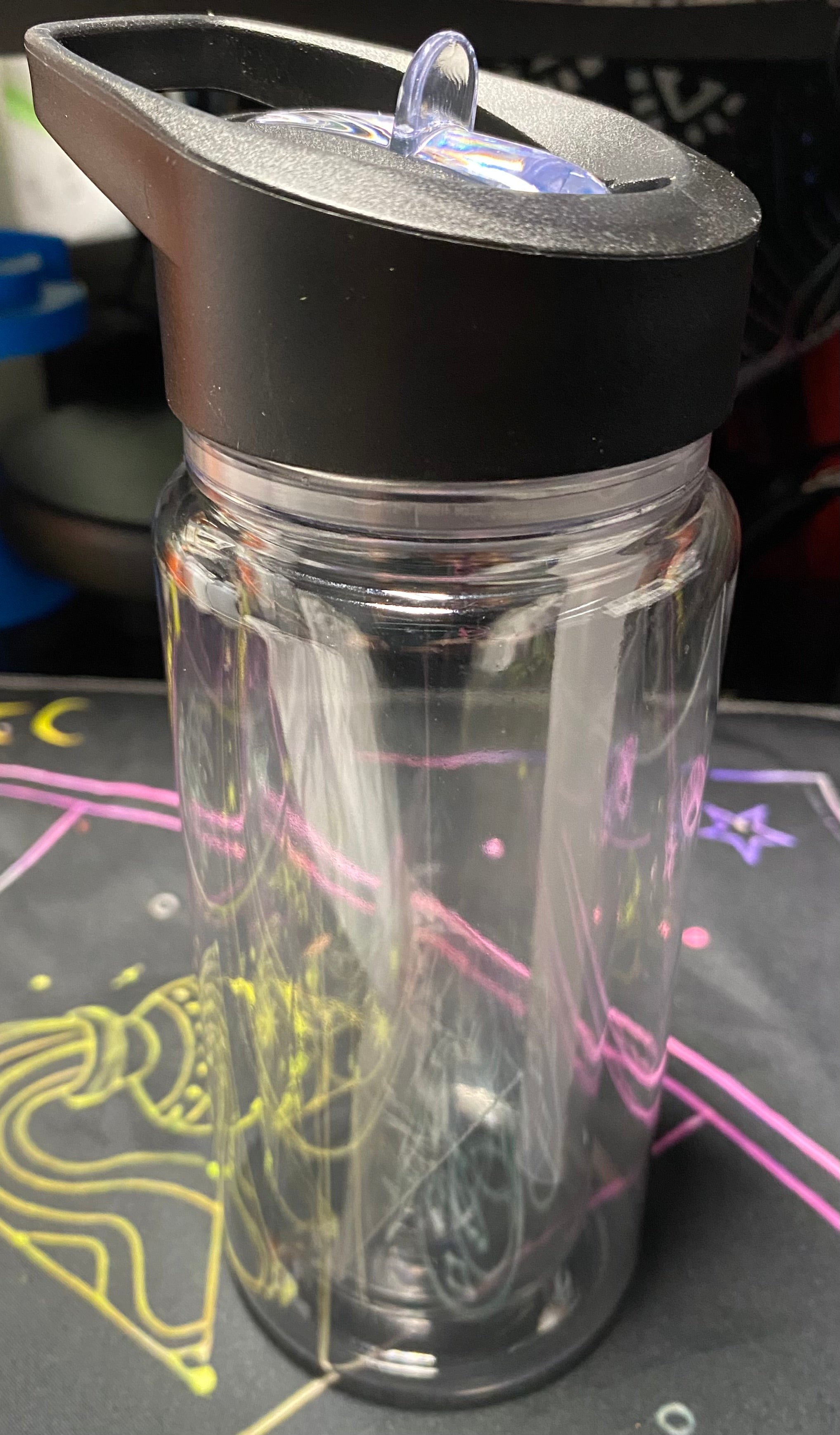 Clear glass tumbler with black lid
