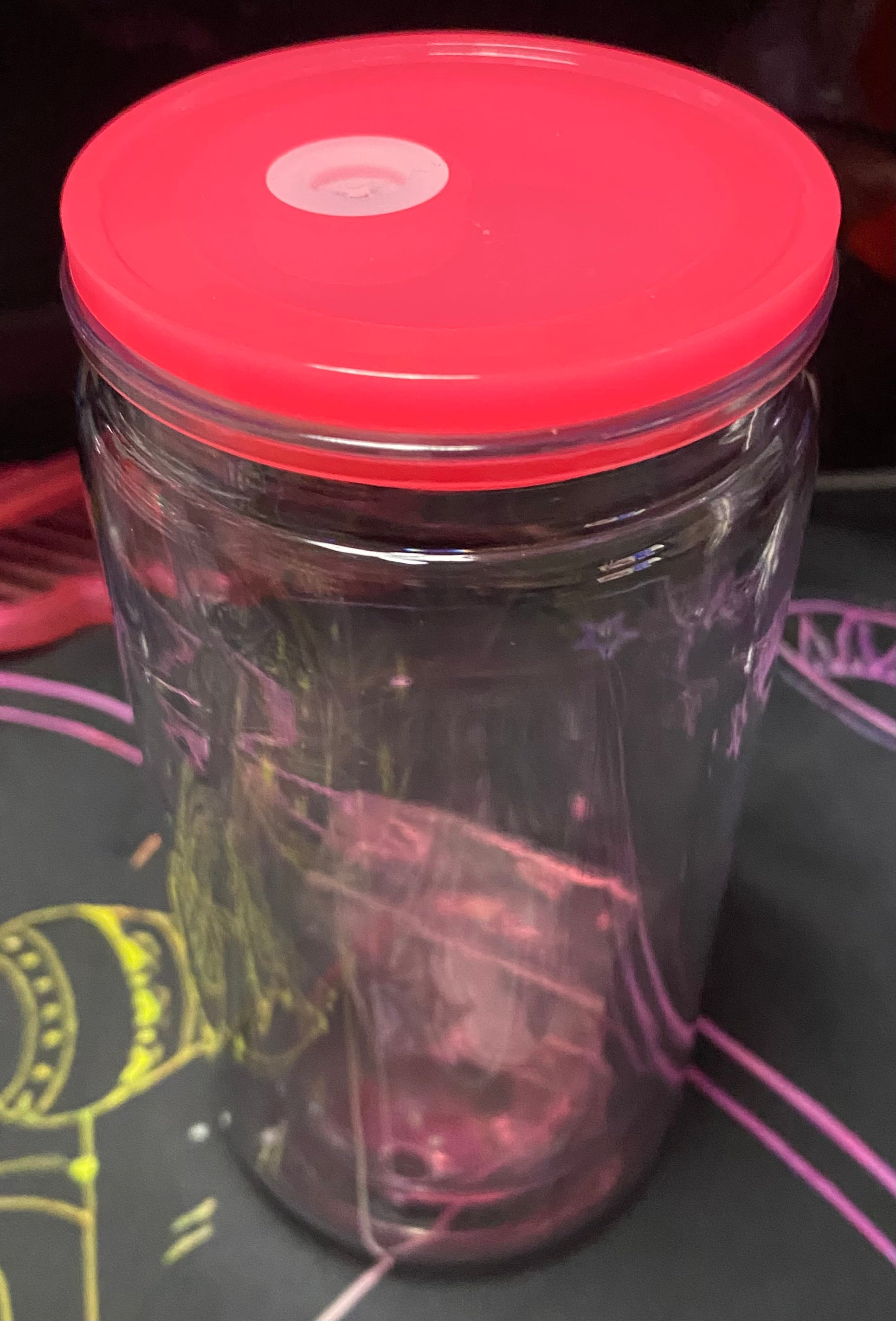 Clear container with a dark pink lid