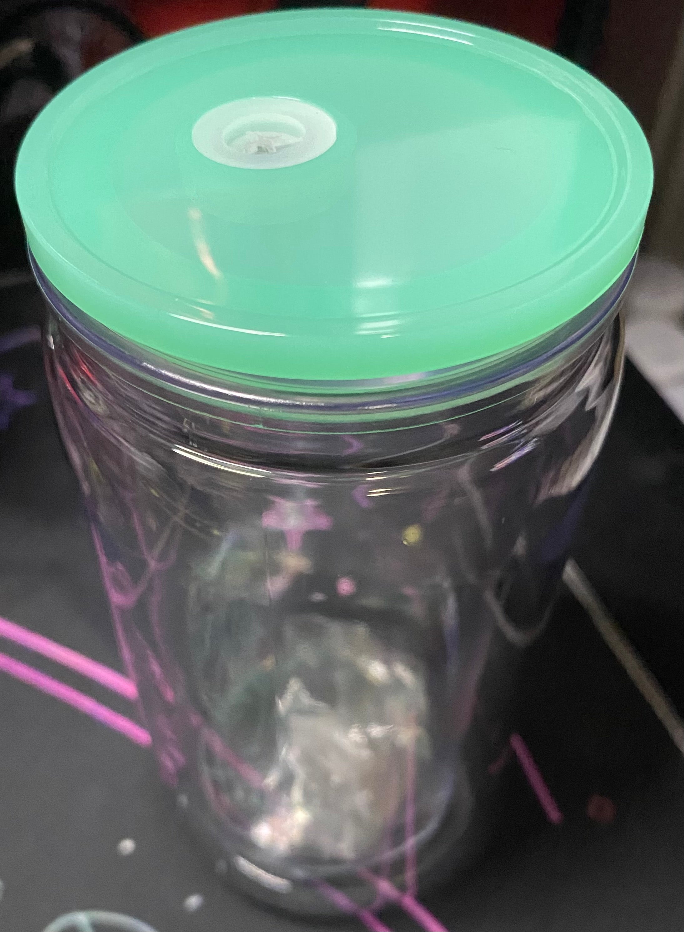 Clear tumbler with a green lid 