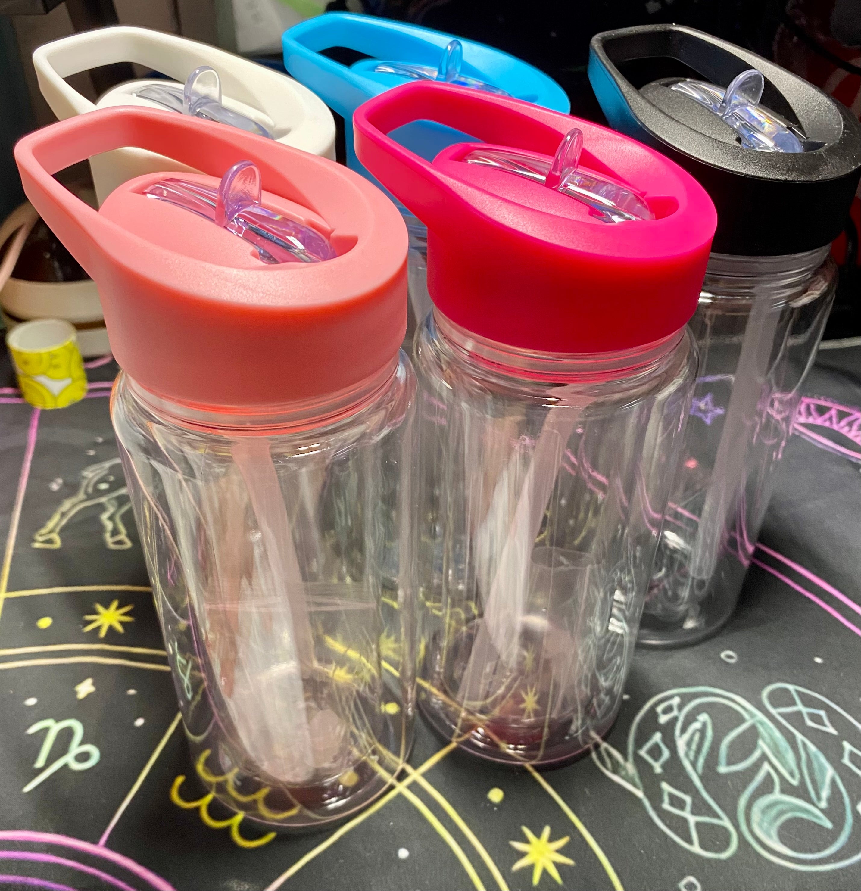 Clear bottle with different colored lids