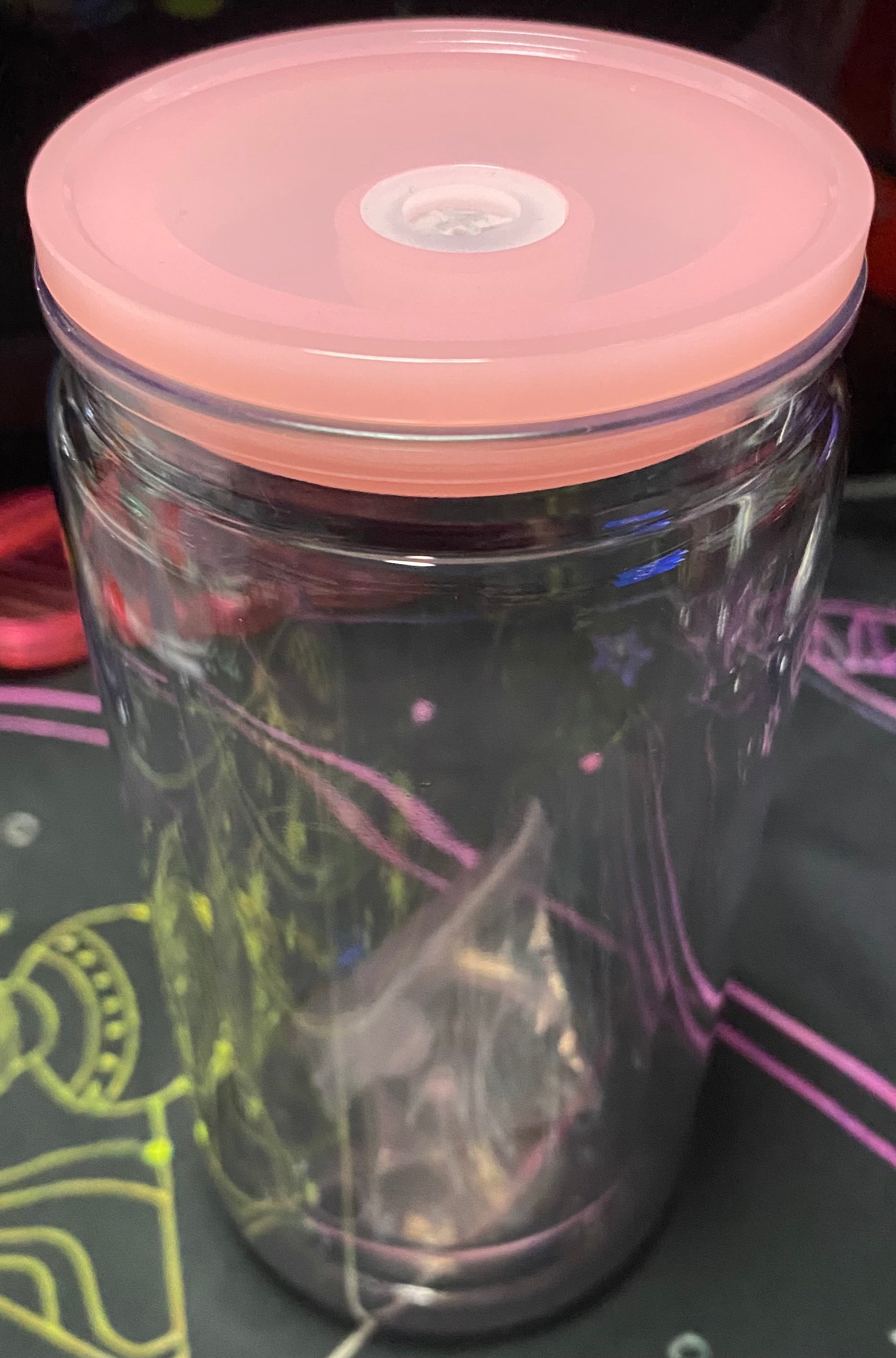 Clear plastic jar with a pink lid