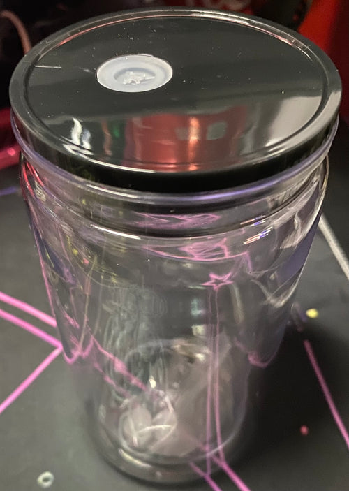 Clear glass tumbler with a black lid